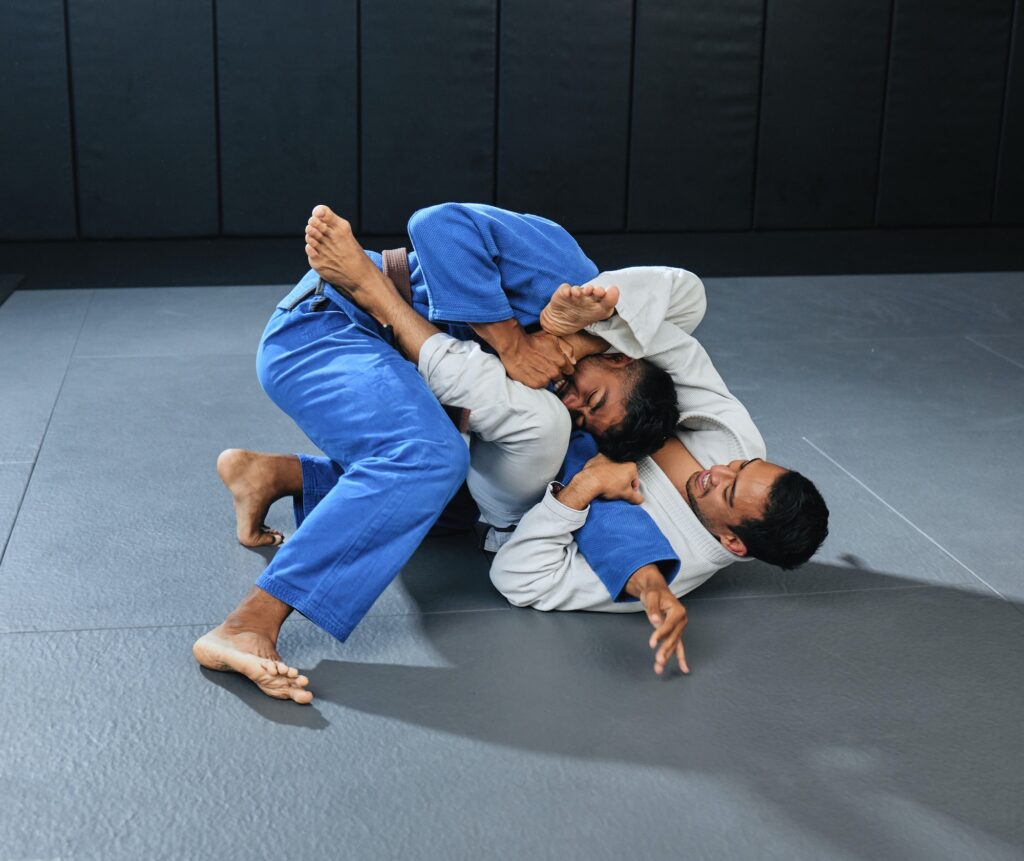 Mma, martial arts and fighting with a student and teacher grappling on the ground during a lesson o
